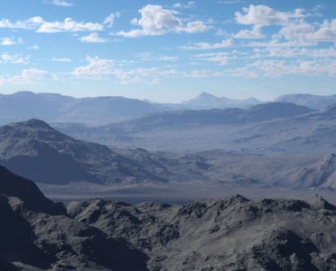 A 3D rendering of a wide mountainous desert landscape