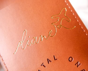 Elegant hot foiling calligraphy with metallic accents on a luggage tag by NYC calligrapher