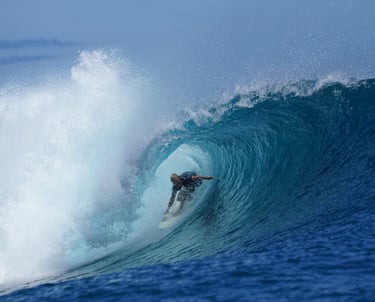 Surfer deep inside turquoise barrel at secret Mentawai surf spot