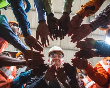 a group of people in a circle with their hands together