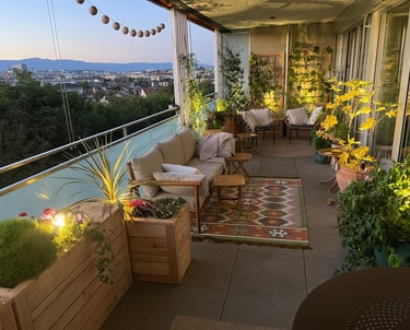 a balcony with a couch and chairs and a rug