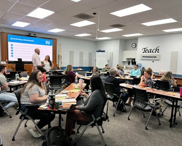 Educators collaborating in a professional development workshop classroom.