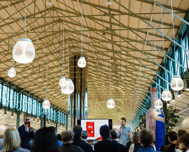 Inside of a large building with people participating at en event
