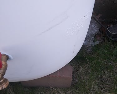 A Rain Barrel been leveled on bricks to insure it does not tip over.