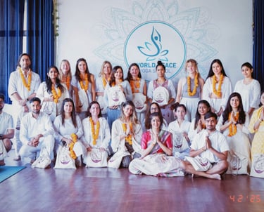 A group picture of people who have been certified as yoga instructors.