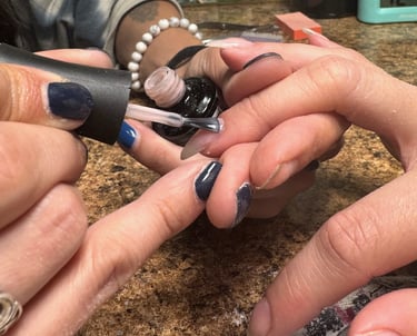Alex applying polish to acrylic nails in downtown Missoula