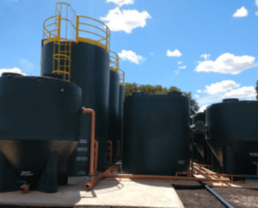 a large group of tanks with a yellow ladder