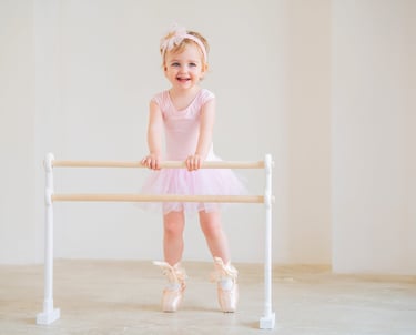 a little girl in a pink dress and ballet shoes, pre ballet