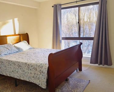 Comfortable primary bedroom with large windows at Apartment for Rent Anacostia DC, 1719 Gainesville