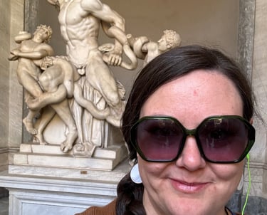 Cassie standing in front of Laocoon, a sculpture in the Vatican