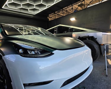Dramatic color transformation: White Tesla receiving a high-quality green vinyl wrap at Bluemax Tint