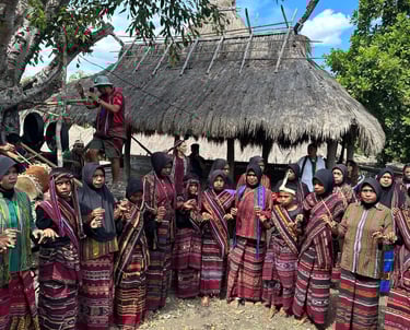 Tribe in Bampalola village singing and dancing in alor in front of their traditional house