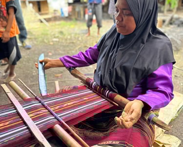 Artisan demonstrating Ikat weaving techniques in Uma Pura Village in alor