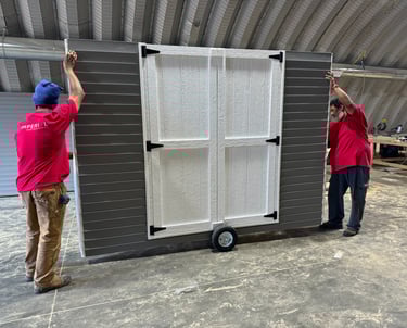 Imperial Custom Sheds crew moving a shed wall to load onto delivery truck for on-site installation