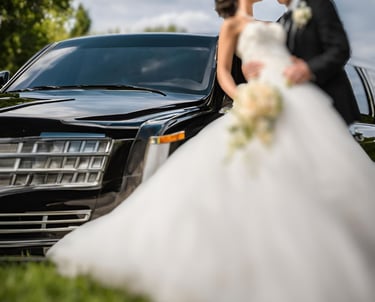 a bride and groom kissing in front of a limo limo