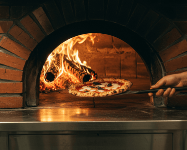 a pizza oven with a pizza being cooked in it