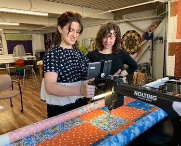 Quilting students at the longarm