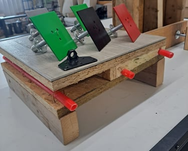 Mounted color-coded anchor plates displayed on a construction test setup for framing and insulation systems