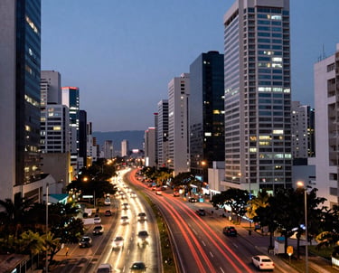 Photography of a modern city expressway at dusk with vibrant car light trails and high-rise buildings in a South American metropolis.