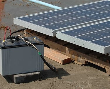 Portable solar panel array connected to a deep cycle battery for off-grid power generation.