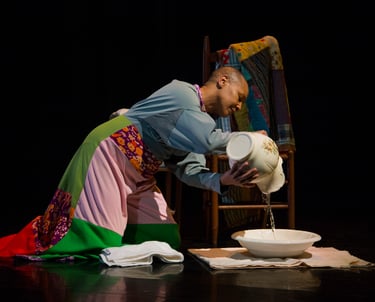 Anjali on stage during a performance with the quilts and water