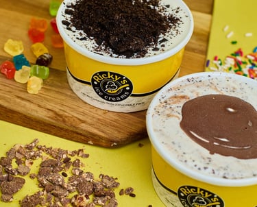 two cups of ice cream with chocolate chips and candy