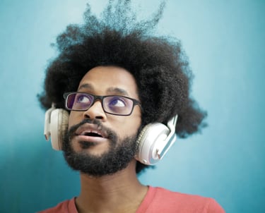 a man with a beard and glasses with headphones on