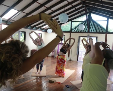 a group of people doing yoga exercises in a room