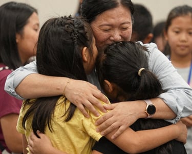 A group of children sitting on the ground playing a game