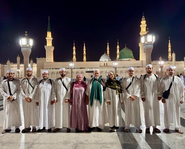 a group of people standing in front of the Majid an Nabi in Medina Almunawara