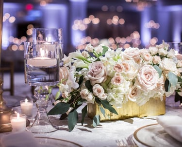 Floral centerpiece with tea light candles used to elevate the space.