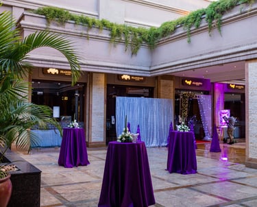 foyer of corporate event with high top tables and floral center pieces