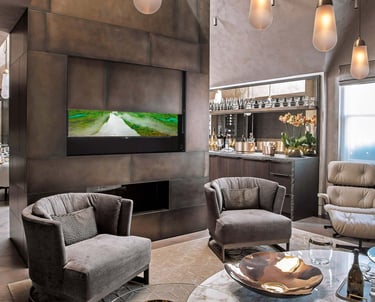 Bespoke media wall featuring an automated drop-down moving panel to conceal a large TV in apartment