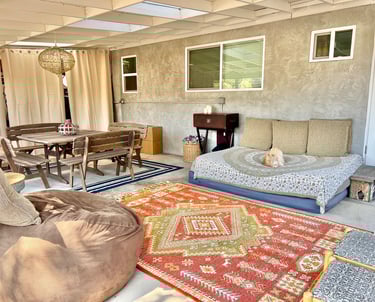 Covered outdoor lounge workspace and large table and ground spaces for therapeutic art expression