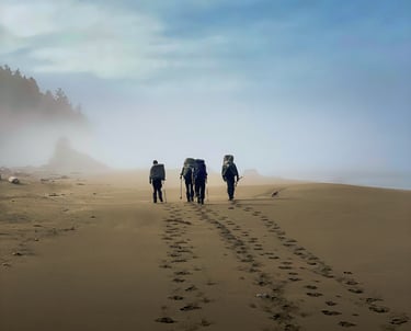 Group of backpackers hiking along a beach, showcasing adventure travel, exploration, and immersive
