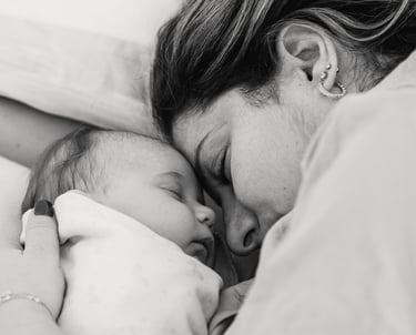 Postpartum Home Care - a woman is holding a baby in her arms
