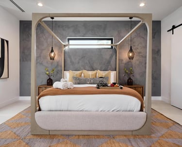 Soft gray limewash accent wall in a modern bedroom, featuring a textured, matte finish for a subtle yet elegant organic look