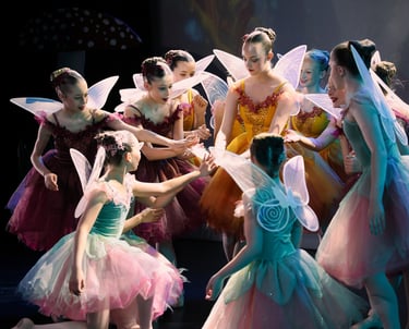 a group of young girls dressed in fairy - themed costumes