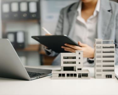 a woman in a business suit is holding a tablet and a tablet
