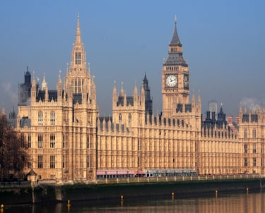 a large building with a clock tower in the background