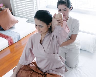 a woman in a robe is sitting on a bed