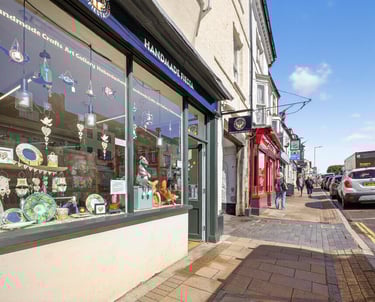 a store front window with a car parked in front of it