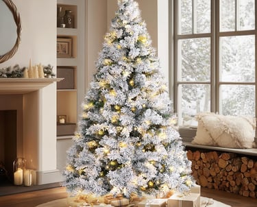 a christmas tree with presents and presents on a rug