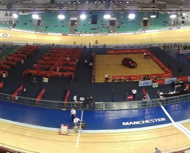 a track cycling track, with track cyclists and crowd