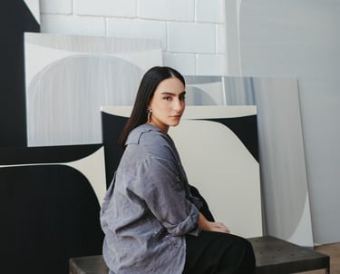 a woman sitting on a bench in a room