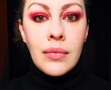 a woman with a red eye makeup and pink eye makeup