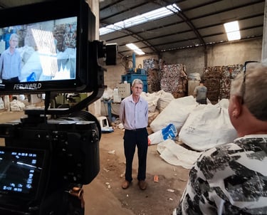 a man is standing in a warehouse with a camera and a video camera