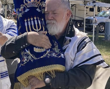 Picture of Rabbi Jay Ledbetter holding Torah Scroll