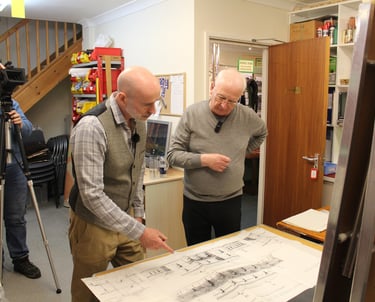 Andrew and Stephen look at station plans together
