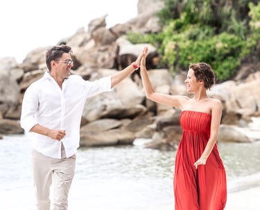 Couple giving high five on beach during Koh Samui photoshoot